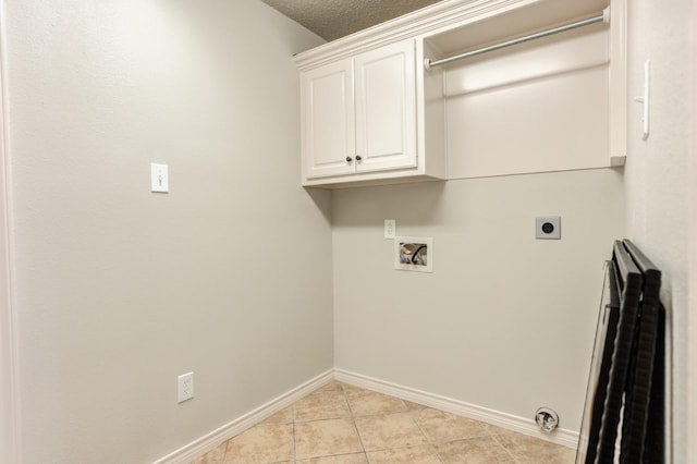 laundry room with light tile patterned flooring, cabinets, a textured ceiling, hookup for a washing machine, and electric dryer hookup