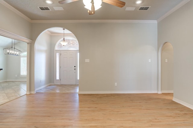 entrance foyer with crown molding, ceiling fan, and light hardwood / wood-style floors