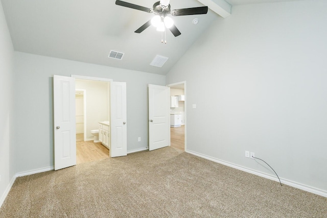 unfurnished bedroom with light carpet, baseboards, visible vents, high vaulted ceiling, and beam ceiling