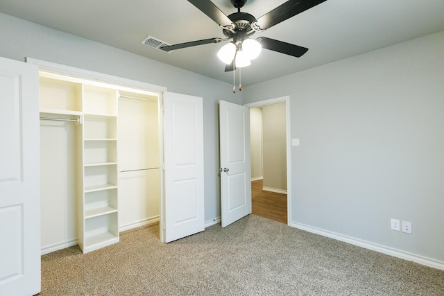 unfurnished bedroom with carpet, a closet, visible vents, a ceiling fan, and baseboards