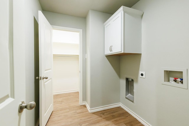 clothes washing area featuring cabinet space, baseboards, hookup for a washing machine, hookup for an electric dryer, and light wood-style floors