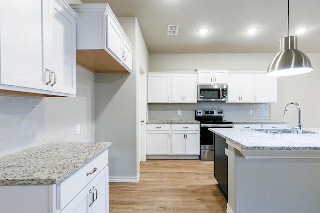 kitchen with visible vents, appliances with stainless steel finishes, light wood-style floors, white cabinetry, and a sink