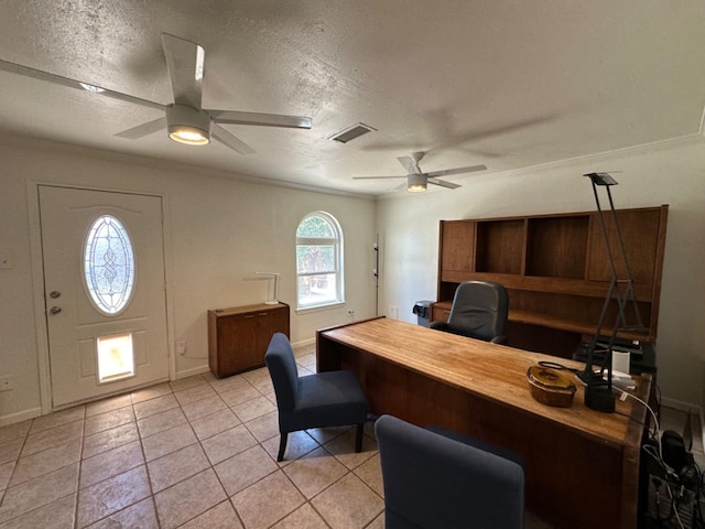 home office featuring ceiling fan, ornamental molding, a textured ceiling, and light tile patterned floors