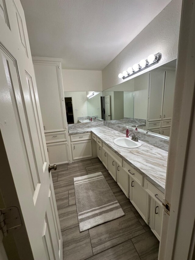 bathroom with vanity and a textured ceiling