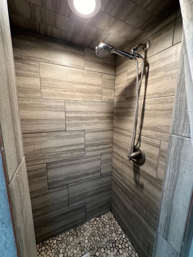 bathroom with tiled shower