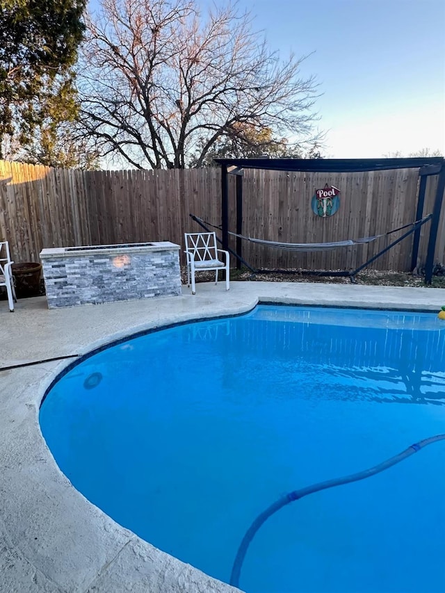 view of pool with an outdoor fire pit