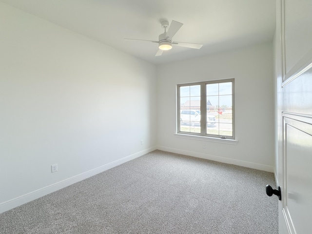 empty room with baseboards, light colored carpet, and ceiling fan