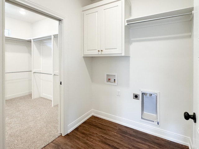 washroom with hookup for an electric dryer, cabinet space, dark wood finished floors, baseboards, and washer hookup