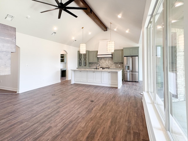 unfurnished living room with dark wood finished floors, visible vents, beamed ceiling, ceiling fan, and high vaulted ceiling