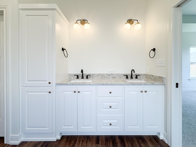 full bathroom with wood finished floors and a sink