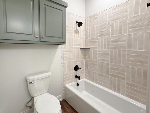 full bathroom with shower / bathtub combination, toilet, baseboards, and wood finished floors