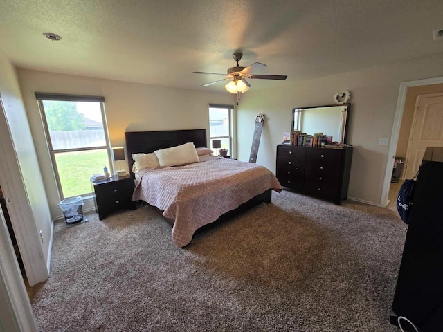 carpeted bedroom featuring a textured ceiling and ceiling fan