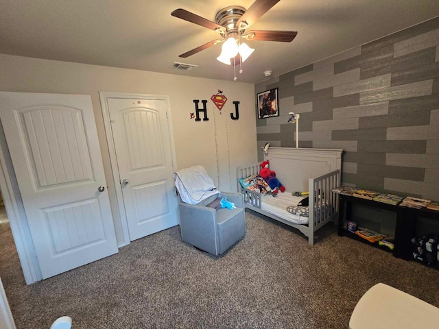 bedroom featuring ceiling fan and dark colored carpet