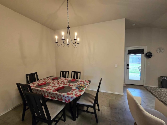 dining space with a chandelier and tile patterned flooring