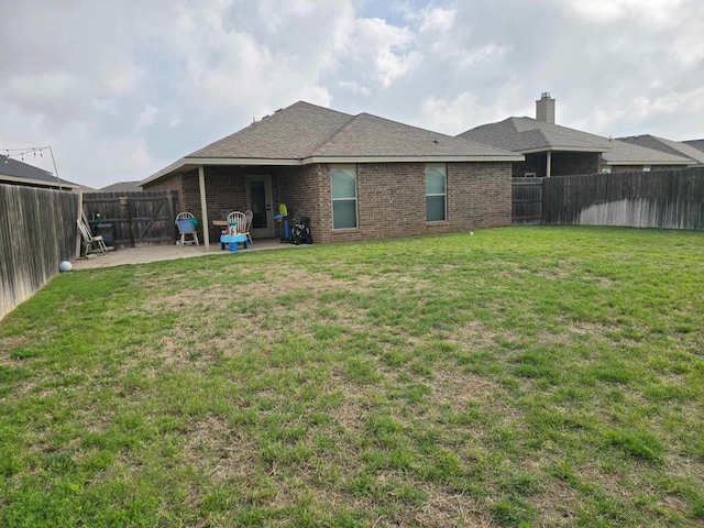 back of house with a yard and a patio area