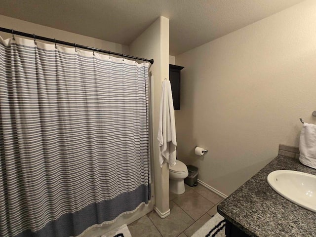 bathroom featuring vanity, tile patterned flooring, curtained shower, and toilet