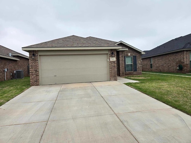 ranch-style home featuring a garage, a front yard, and central AC unit