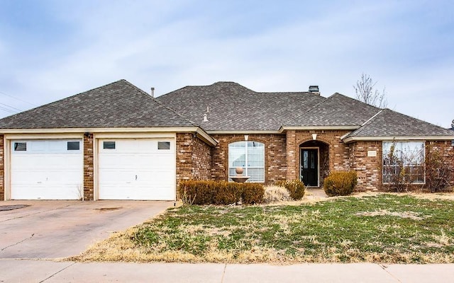 view of front of property with a garage and a front yard