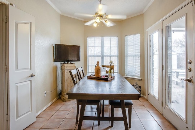 dining room featuring light tile patterned flooring, ceiling fan, and crown molding