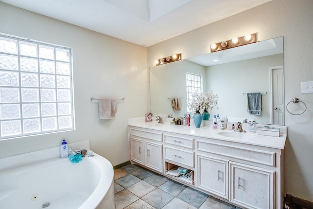 bathroom with tile patterned flooring, vanity, and a bathtub