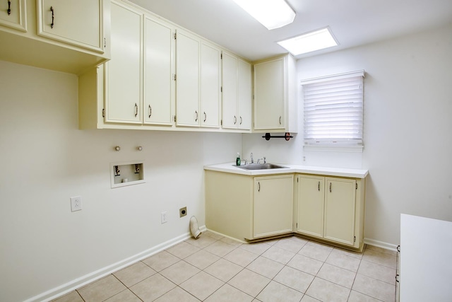 washroom featuring sink, cabinets, light tile patterned floors, washer hookup, and hookup for an electric dryer