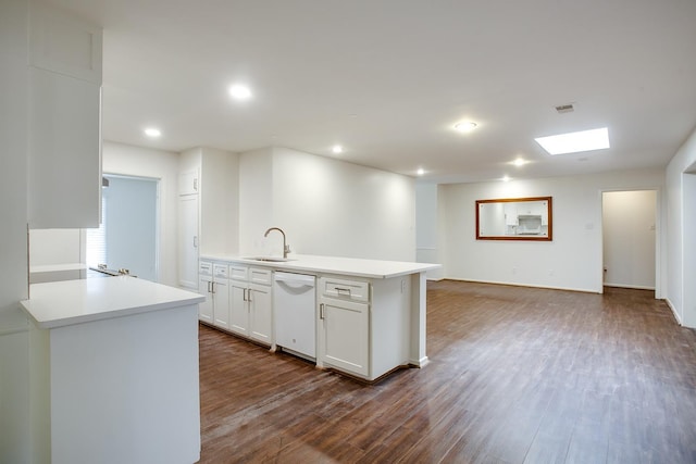 kitchen with white cabinetry, dark hardwood / wood-style floors, white dishwasher, and sink