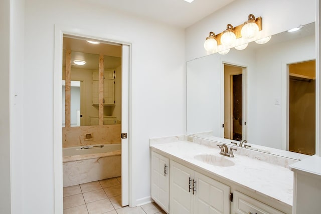 bathroom with vanity, tile patterned flooring, and a washtub