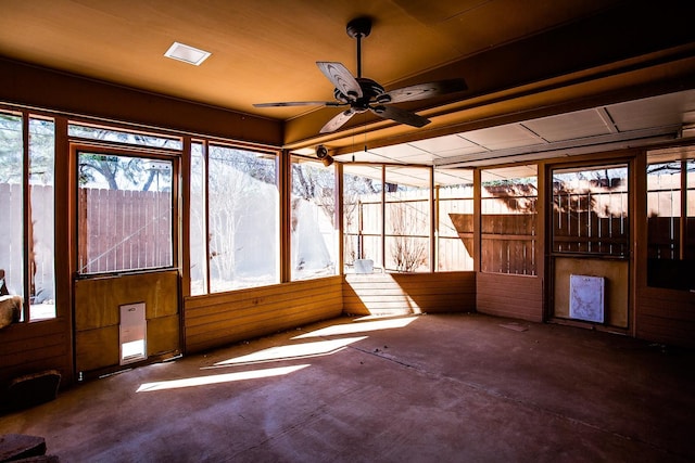 unfurnished sunroom with ceiling fan