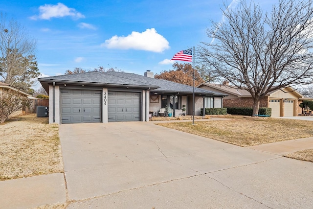 single story home featuring a garage and a front yard