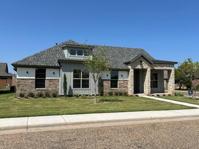 1312 Chaucer Ln, Wolfforth, TX 79382 - view of front of home featuring board and batten siding, a front lawn, and roof with shingles