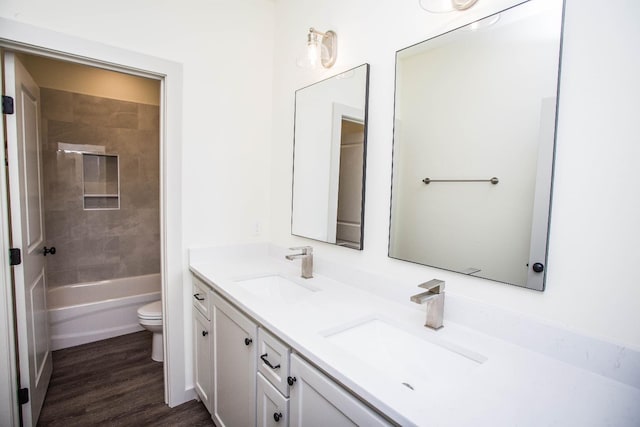 1312 Chaucer Ln, Wolfforth, TX 79382 - bathroom with double vanity, wood finished floors, and washtub / shower combination