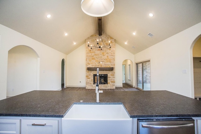 1312 Chaucer Ln, Wolfforth, TX 79382 - kitchen with stainless steel dishwasher, open floor plan, arched walkways, a chandelier, and beamed ceiling