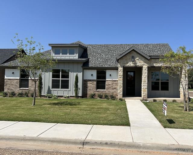 1312 Chaucer Ln, Wolfforth, TX 79382 - view of front of home featuring board and batten siding, a front lawn, and a shingled roof