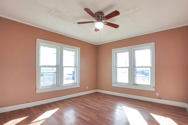 unfurnished room with plenty of natural light, hardwood / wood-style floors, and ceiling fan