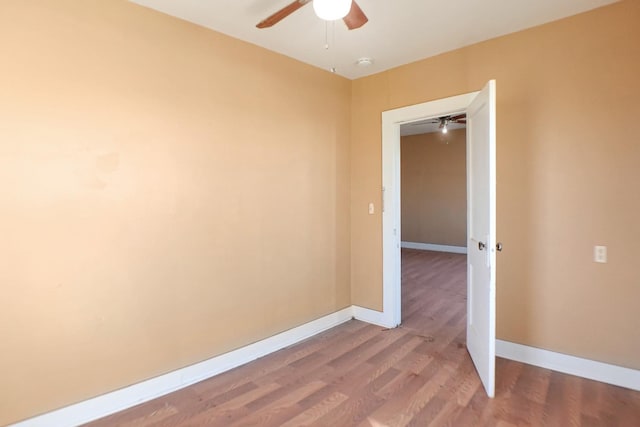 unfurnished room featuring hardwood / wood-style floors and ceiling fan