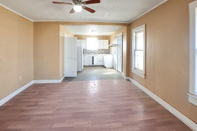 interior space with crown molding, ceiling fan, and light wood-type flooring