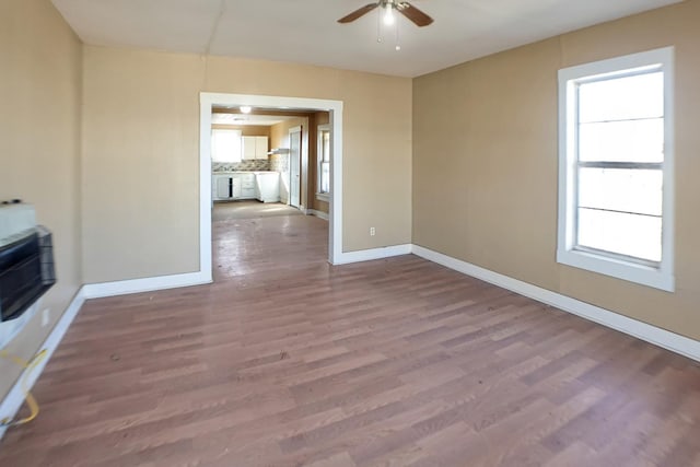 unfurnished living room featuring hardwood / wood-style floors and ceiling fan