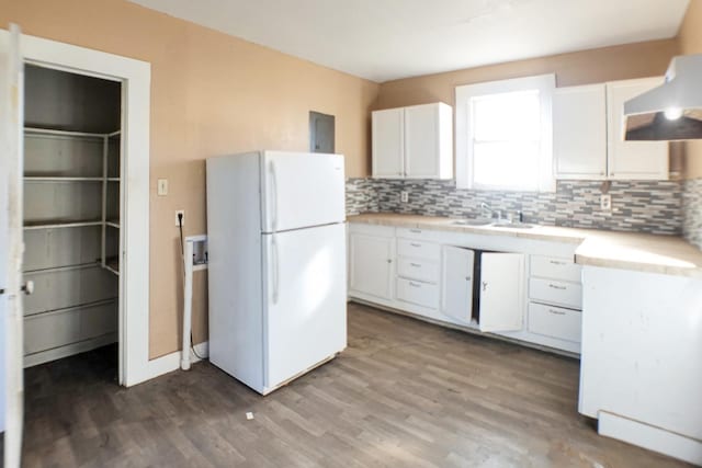 kitchen with sink, wood-type flooring, white refrigerator, decorative backsplash, and white cabinets