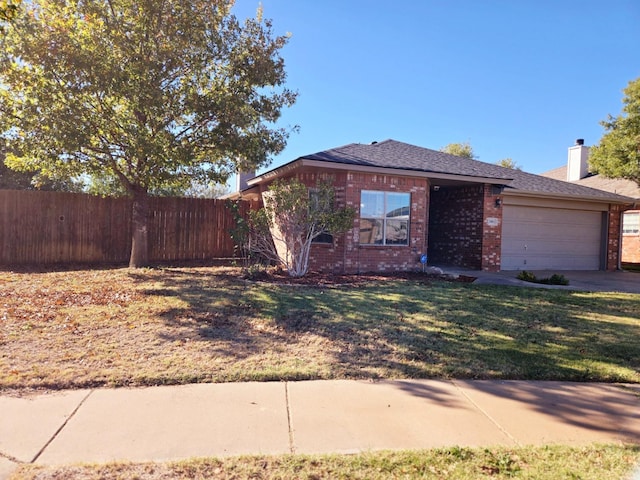 single story home featuring a garage and a front yard