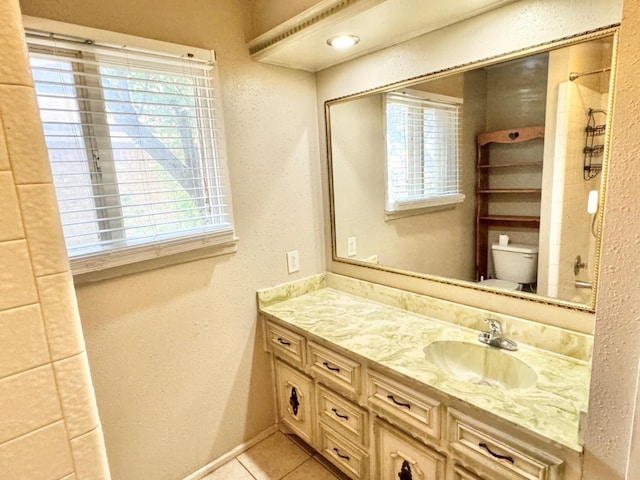 bathroom with vanity, tile patterned floors, and toilet