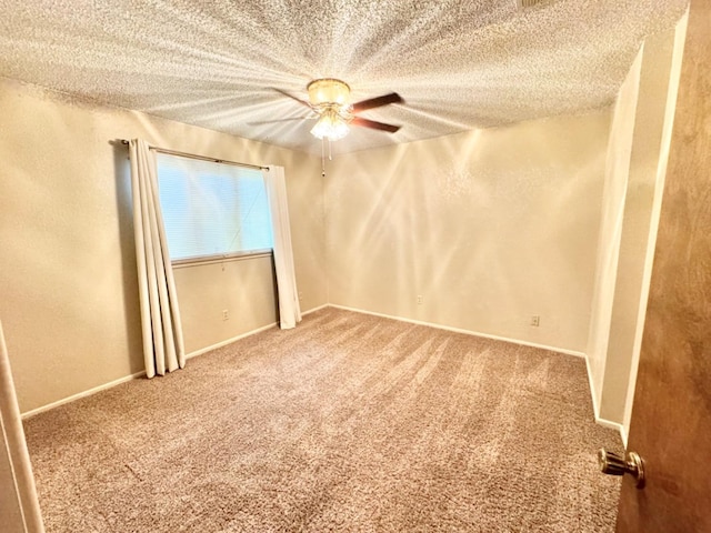 carpeted empty room featuring a textured ceiling