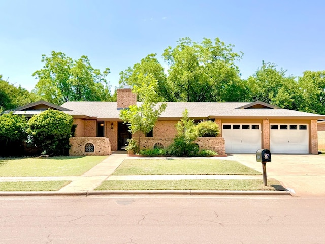 view of front of property featuring a garage and a front lawn