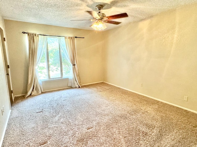 spare room with ceiling fan, carpet flooring, and a textured ceiling