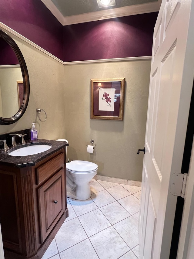 bathroom with vanity, crown molding, tile patterned floors, and toilet