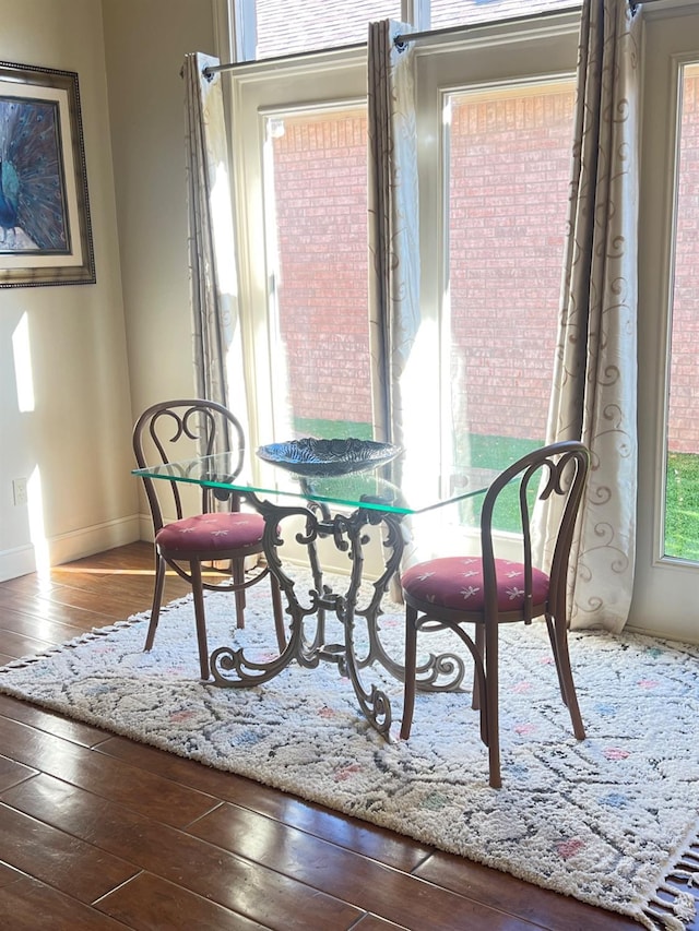 dining space with wood-type flooring