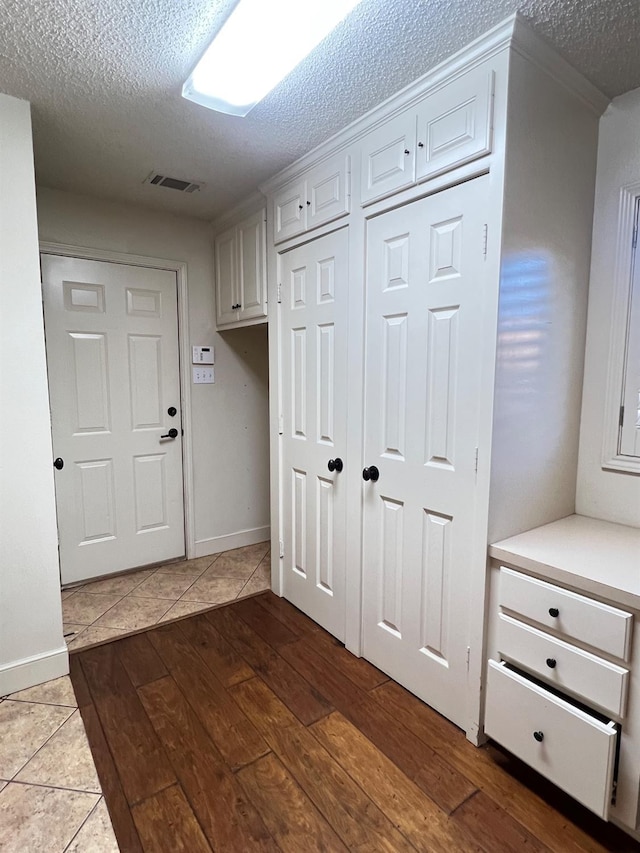 mudroom featuring hardwood / wood-style flooring and a textured ceiling