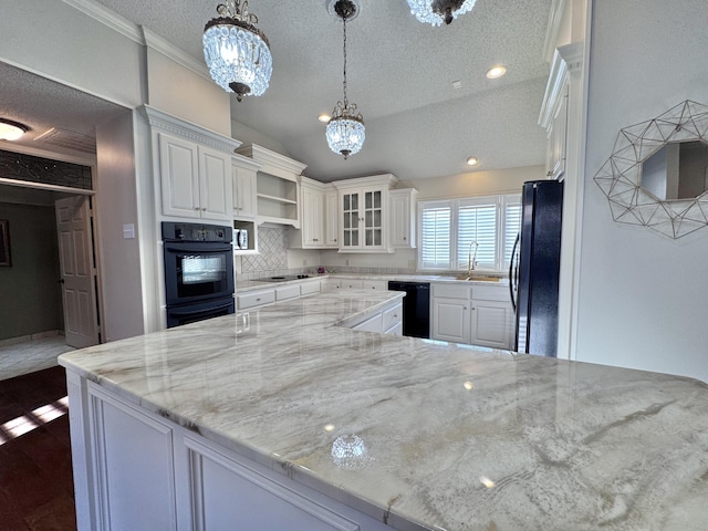 kitchen with white cabinets, a textured ceiling, a sink, and black appliances
