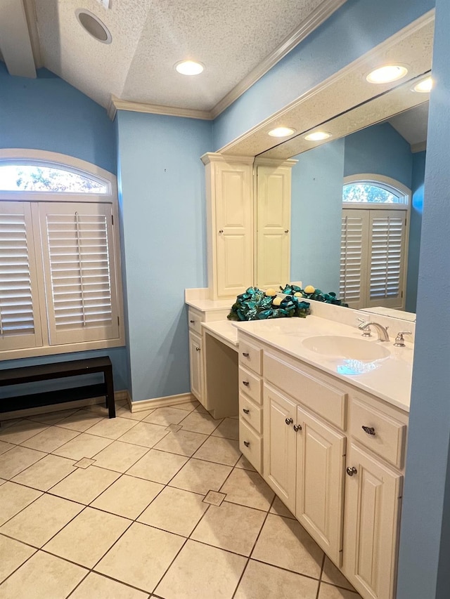 bathroom with tile patterned floors, vanity, a textured ceiling, and a wealth of natural light