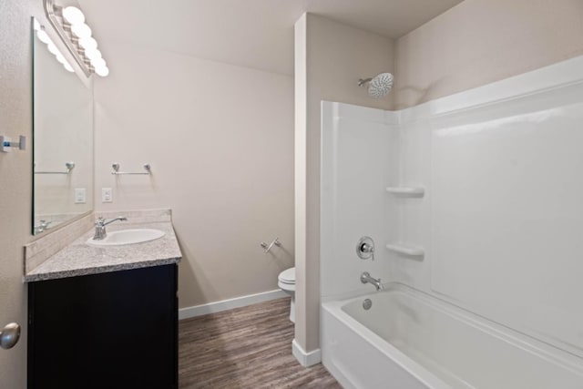 full bathroom with hardwood / wood-style flooring, vanity, toilet, and bathing tub / shower combination