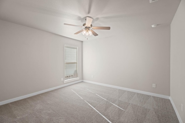 spare room with ceiling fan and carpet flooring